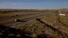 Walt sits in his car on a highway overpass.