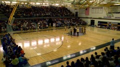 The whole school has a meeting in the gym.