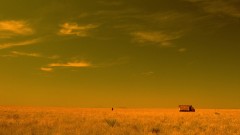 A truck stops in the middle of the desert.