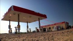 Jesse tanks at a gas station.