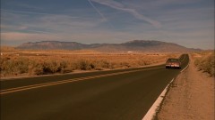 Mike and Jesse are driving through the desert. Alternates with Walt at Los Pollos.