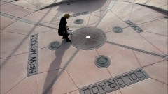 Skylar drives through the desert to the Four Corners Monument.