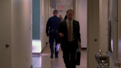 Saul is walking through the police station.