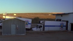 A truck leaves the chicken factory.