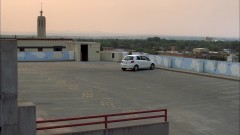 Walt and Jesse meet at a parking garage.