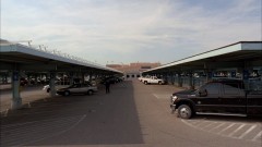 Mike parks his car at the airport.