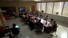 The DEA agents hold a meeting.