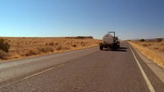 A truck drives throught the desert near the New Mexico border.