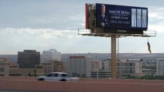 Saul shoots a video at his billboard.