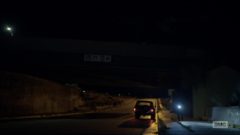 Mike drives at night until he arrives at a bridge