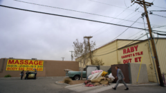 Saul talks to the owners of a carpet shop