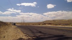 The bus with Jimmy on it is driving through the desert