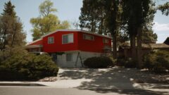 The couple stops at a house that is being painted red